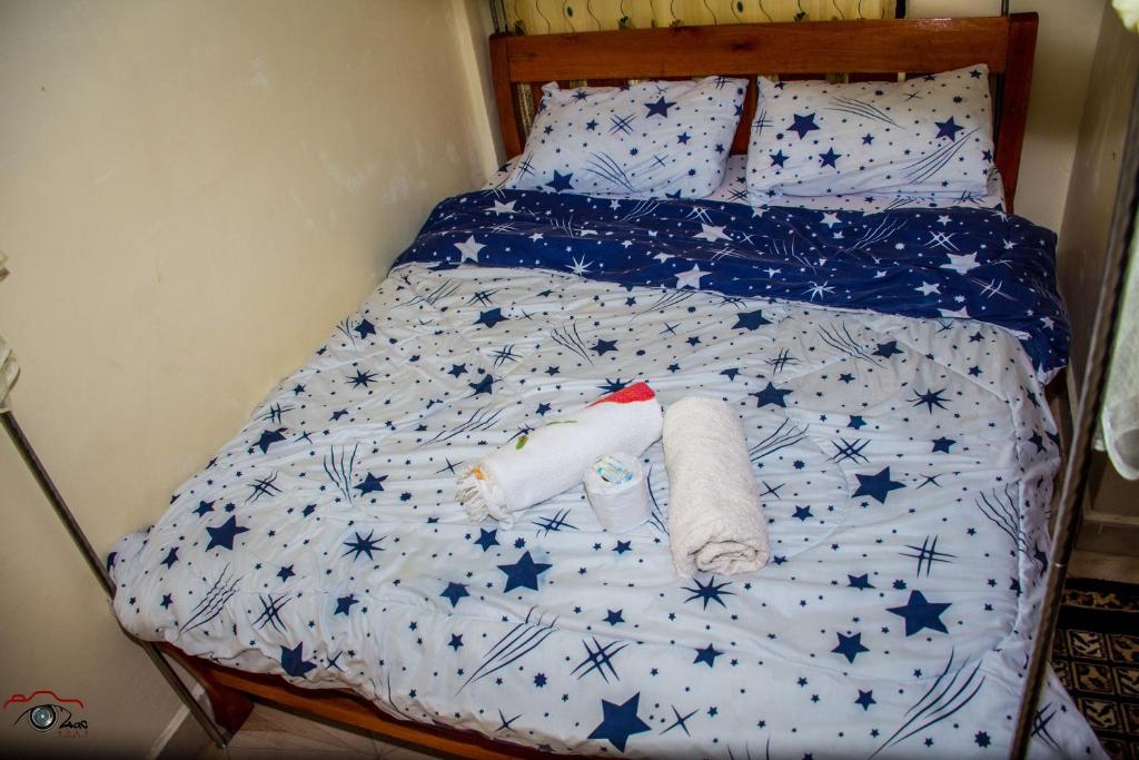 a bed with stars and towels on it at One Bedroom Furnished in Kasarani-Nairobi in Nairobi