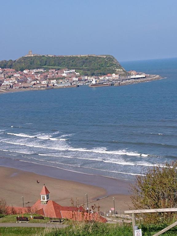 a view of a beach with a town and the ocean at Sandyrise holiday lets in Scarborough