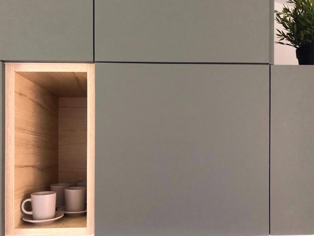 a cupboard with two coffee cups and a potted plant at Apartment Anni in Pula