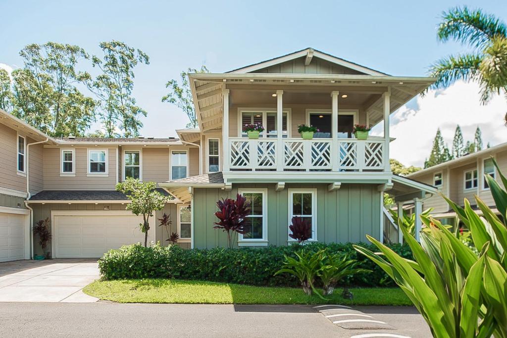 a house with a balcony on a driveway at Nihilani Apartments in Princeville