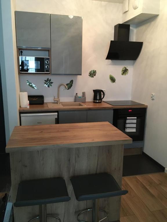 a kitchen with a wooden counter and a sink at MA Sea Apartments - Baltica Towers in Gdańsk