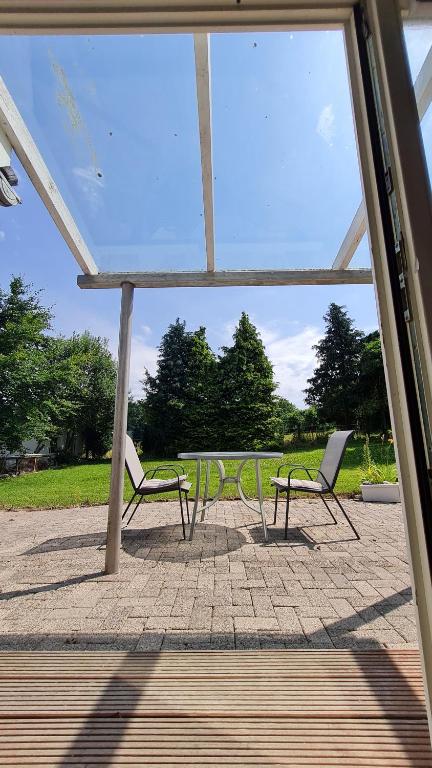 two chairs and a table in a pavilion at Rehbrook in Süsel