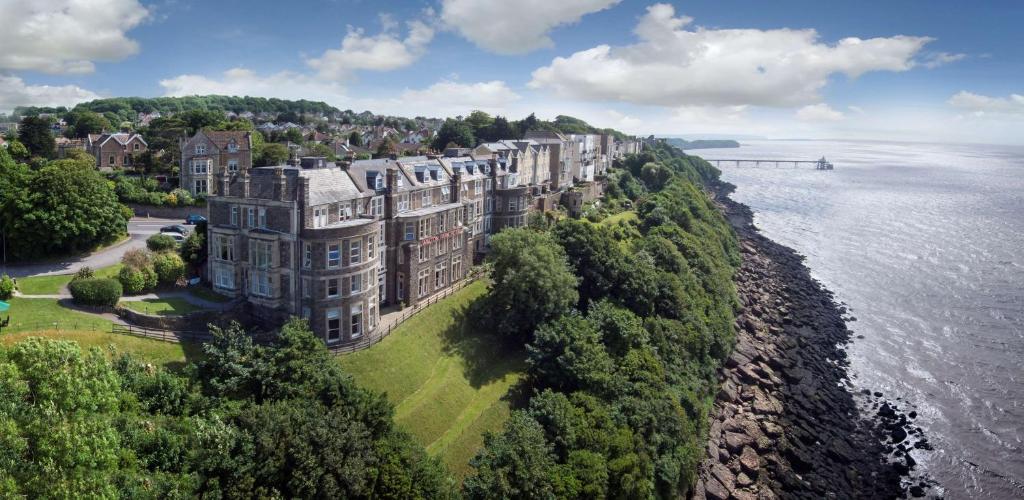 a large building on a hill next to the water at Best Western Walton Park Hotel in Clevedon