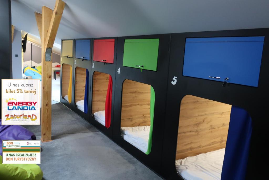 a group of bunk beds in a room at Kapsuła Hostel in Zator