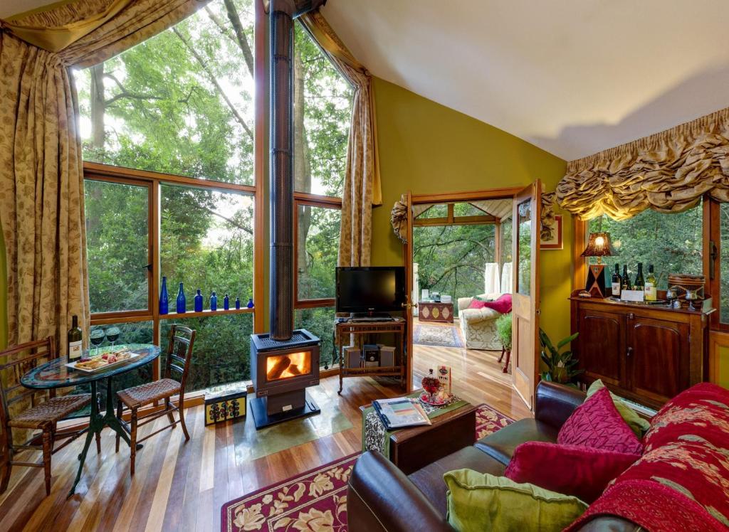 a living room with a couch and a fireplace at Arcadia Cottages in Olinda