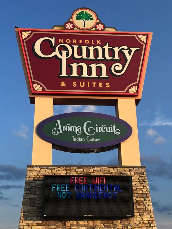 a sign for a monkey country inn and suites at Norfolk Country Inn and Suites in Norfolk