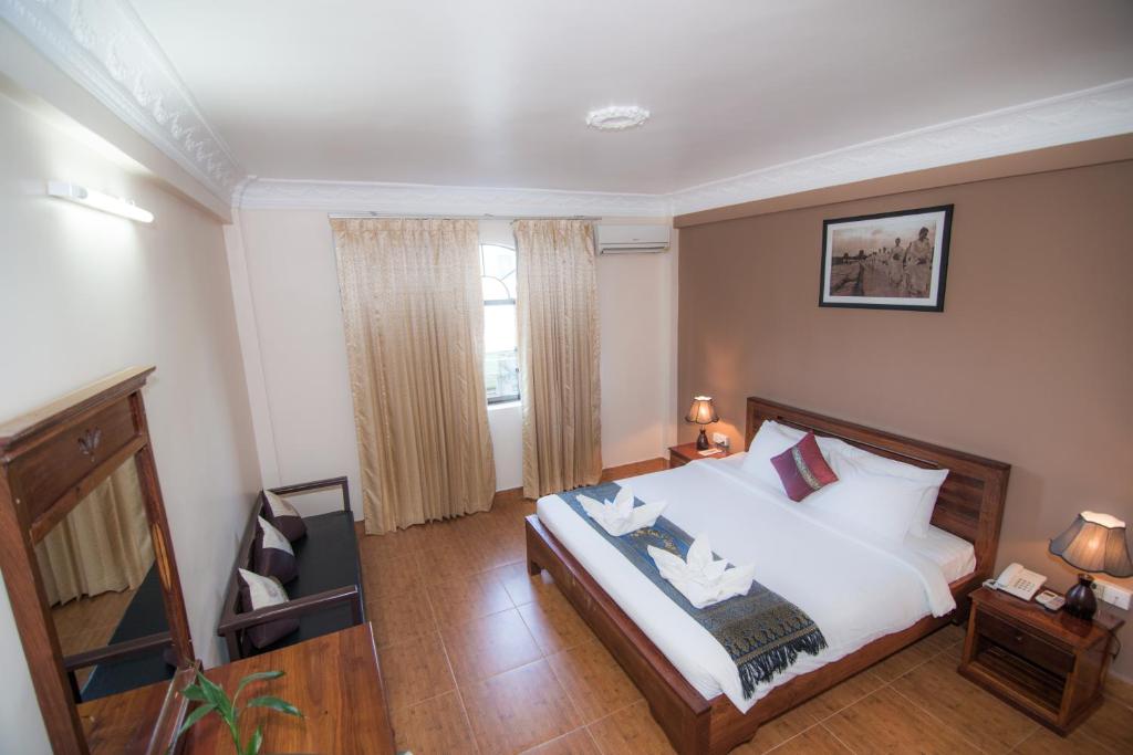 Postel nebo postele na pokoji v ubytování Angkor Pearl Hotel