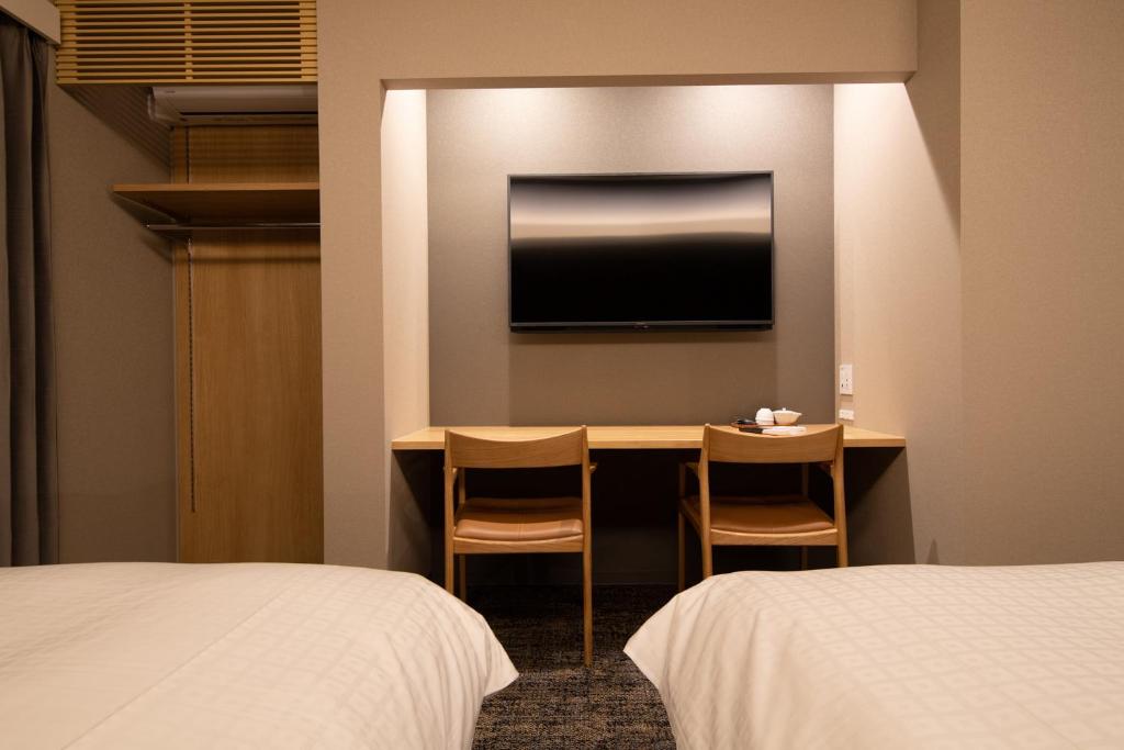 Postel nebo postele na pokoji v ubytování Hotel Celeste Shizuoka