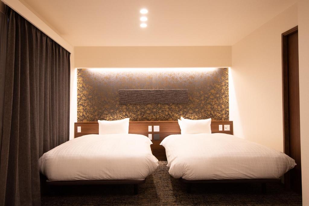 Postel nebo postele na pokoji v ubytování Hotel Celeste Shizuoka