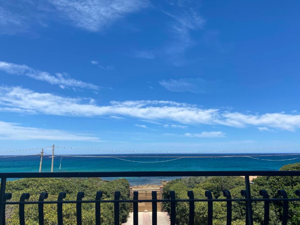 a view of the ocean from a fence at Villa Trinacria - Vintage Luxury villa in the heart of Sicily in Portopalo