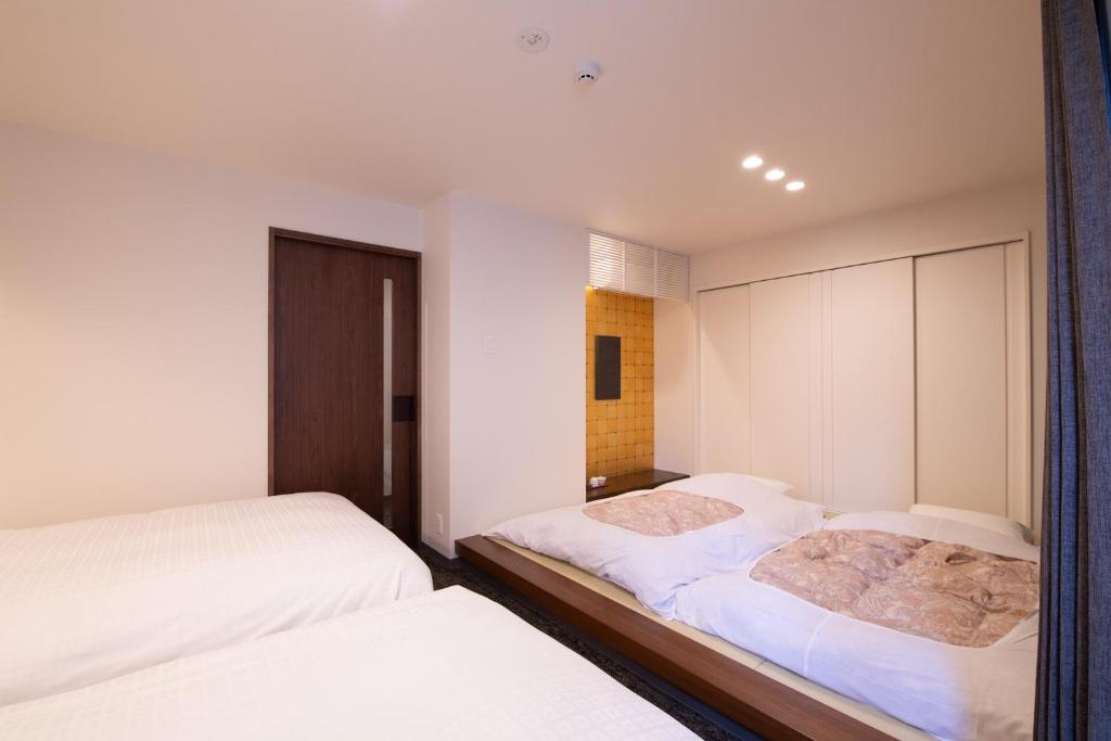 Postel nebo postele na pokoji v ubytování Hotel Celeste Shizuoka