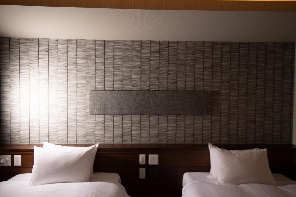 Postel nebo postele na pokoji v ubytování Hotel Celeste Shizuoka