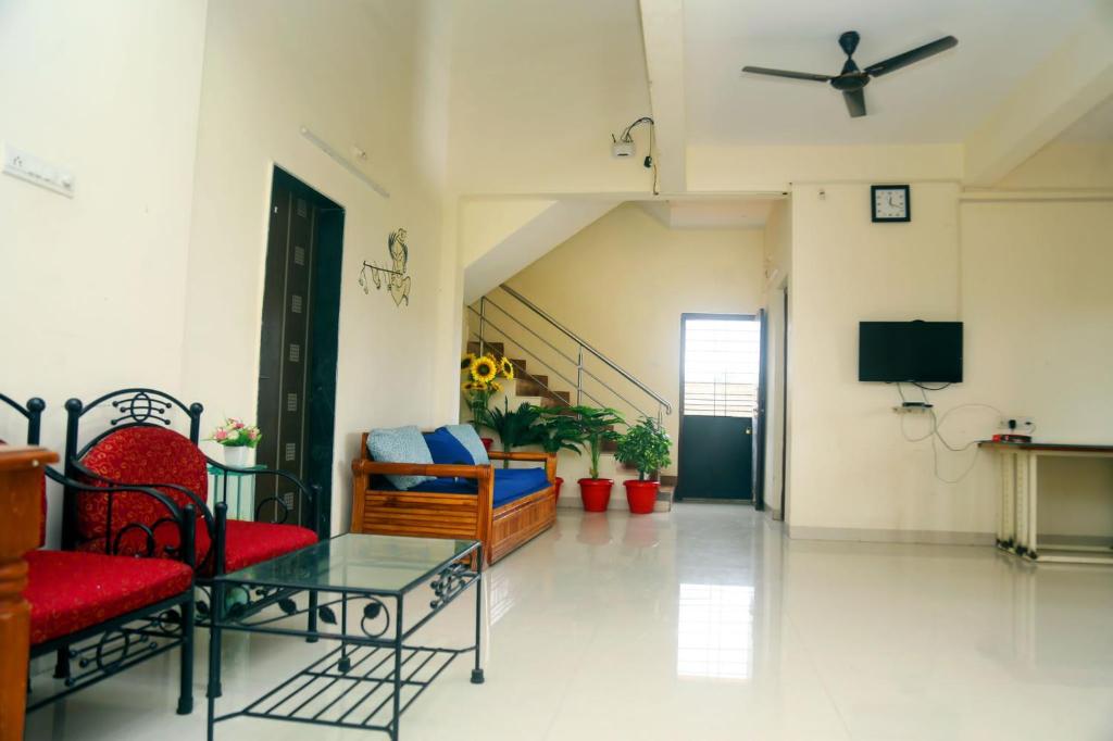 a living room with a couch and a tv at Satyam Villa 5Bhk Lonavala in Lonavala