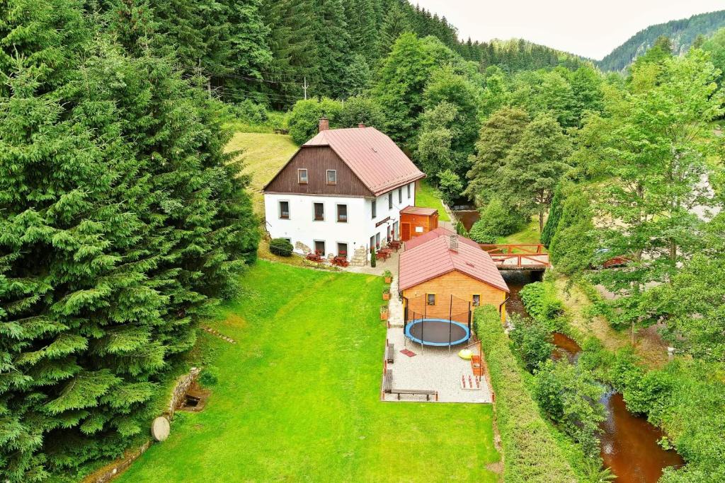 an aerial view of a house in the middle of a forest at Penzion Čtyřlístek in Teplice nad Metují