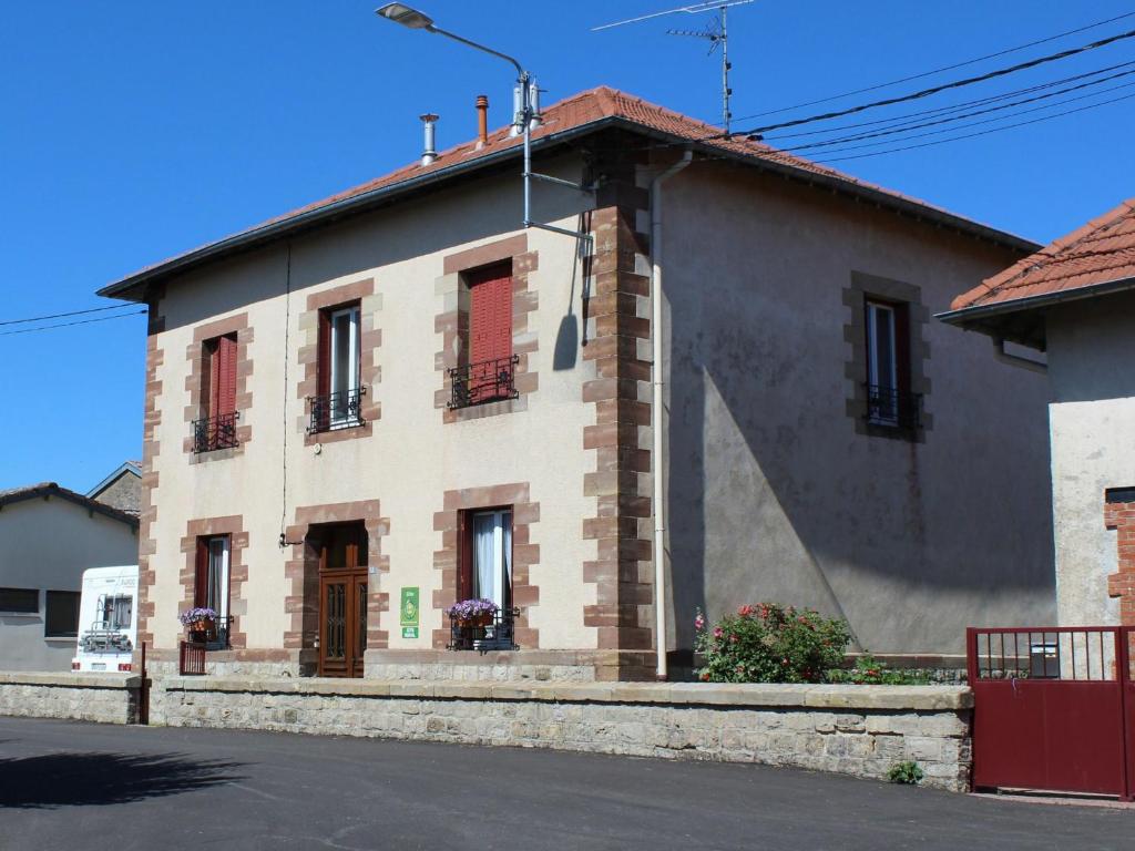 a brick building with red shutters on a street at Gîte Parroy, 4 pièces, 6 personnes - FR-1-584-29 