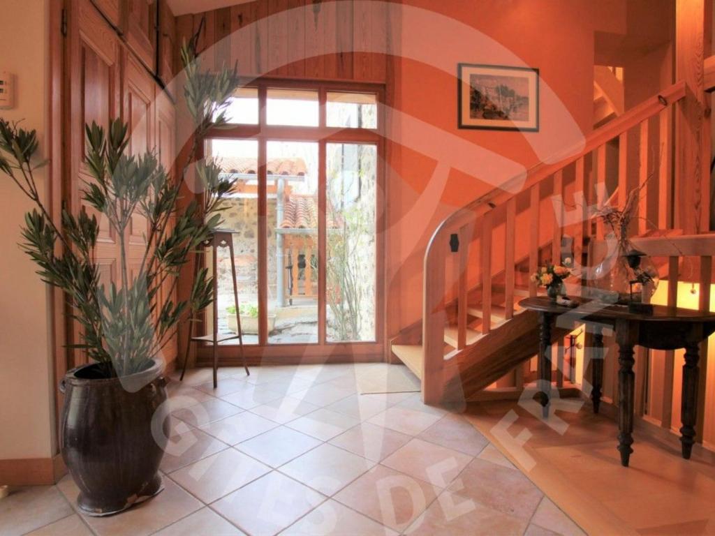 a hallway with a staircase and a potted plant at Gîte Polignac, 3 pièces, 5 personnes - FR-1-582-117 in Polignac