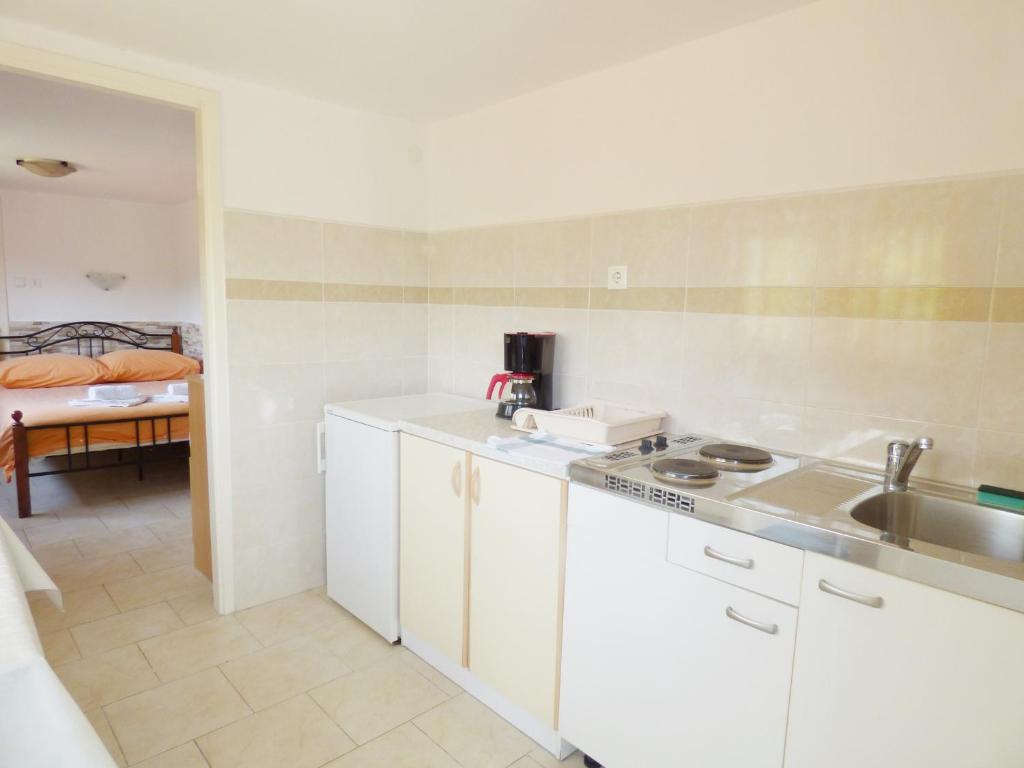 a kitchen with a sink and a counter top at Studio for short stay in Rabac