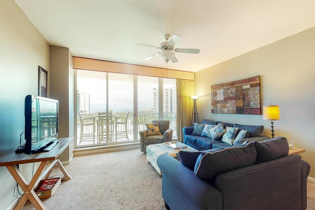 a living room with a blue couch and a tv at St Lucia at Silver Shells in Destin