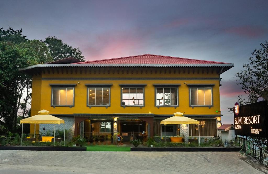 a yellow building with umbrellas in front of it at Sumitel Gangtok Resort in Gangtok