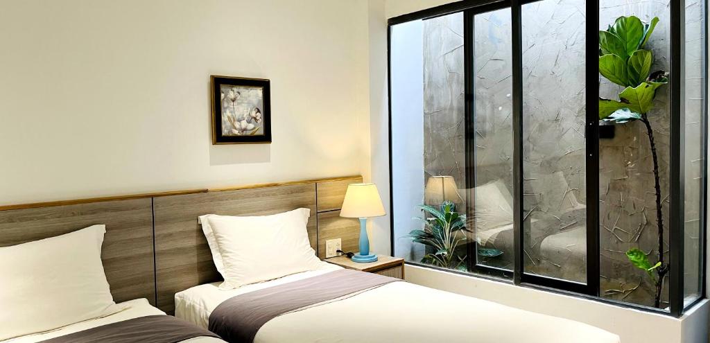 Postel nebo postele na pokoji v ubytování Côn Đảo House