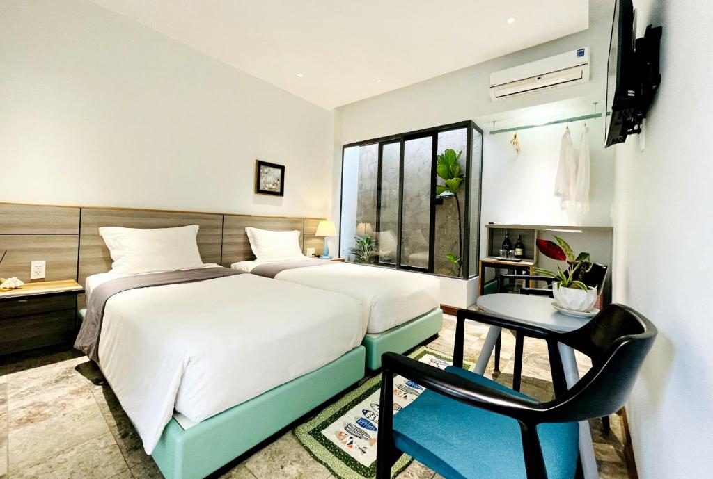 Postel nebo postele na pokoji v ubytování Côn Đảo House
