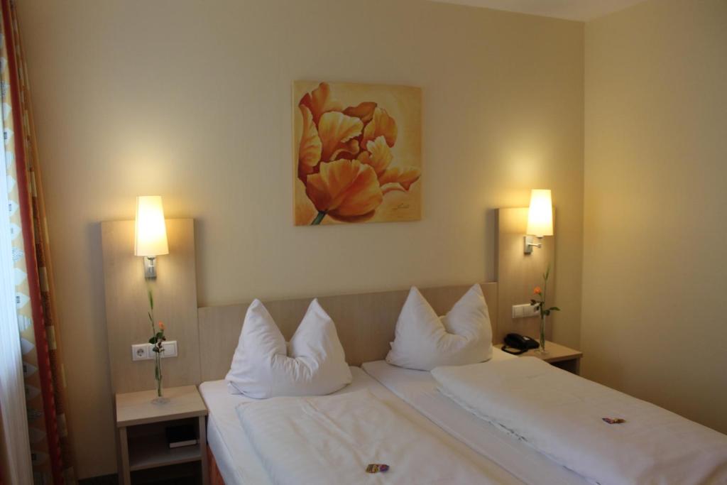 Postel nebo postele na pokoji v ubytování Hotel Petzengarten