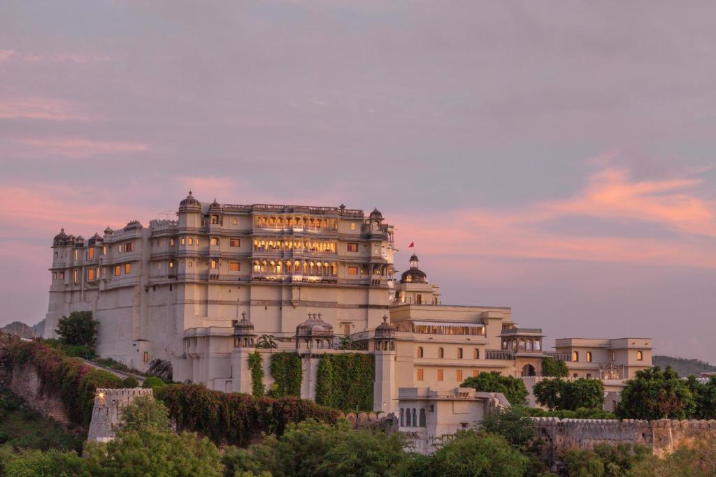 a large building with a clock on the top of it at RAAS Devigarh in Udaipur