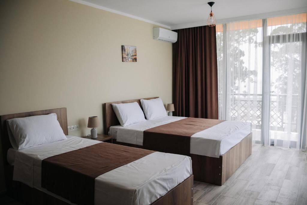 Postel nebo postele na pokoji v ubytování Scorpio Hotel Gonio
