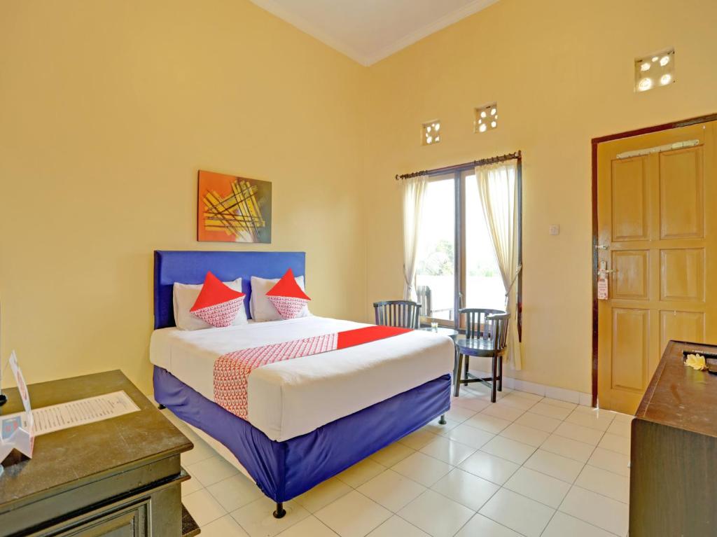 מיטה או מיטות בחדר ב-OYO 3096 Hotel Dewi Warsiki Near Gilimanuk Port