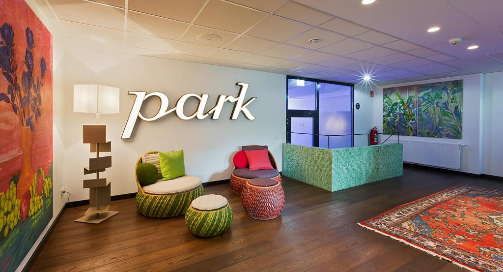 a park store with chairs and a sign on the wall at At the Park Hotel in Baden