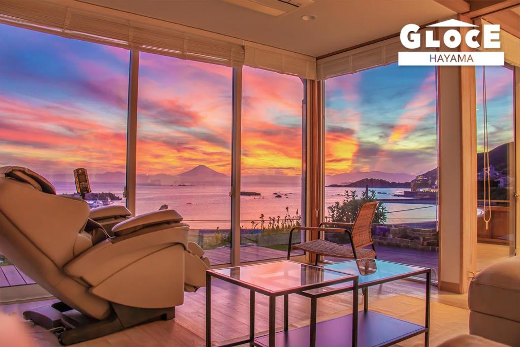 a living room with a view of the ocean at GLOCE 葉山 Ocean View House 都心から1時間 湘南の絶景を独り占めペットok 出張BBQ有り in Yokosuka