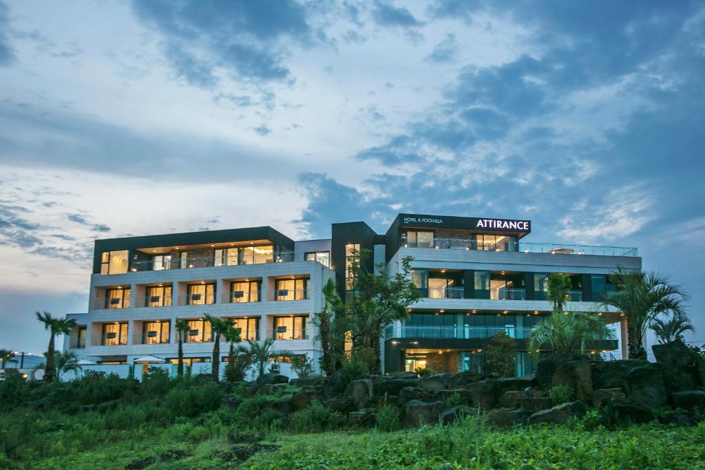 a building with its lights on in front of it at Jeju Attirance in Seogwipo