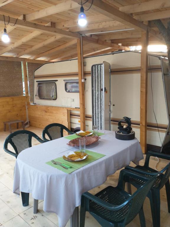 a table and chairs in a room with a caravan at каравана Марбея in Chernomorets
