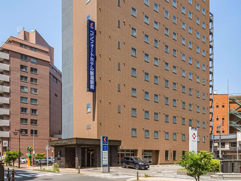 a large building with a sign on the side of it at Comfort Hotel Niigata in Niigata