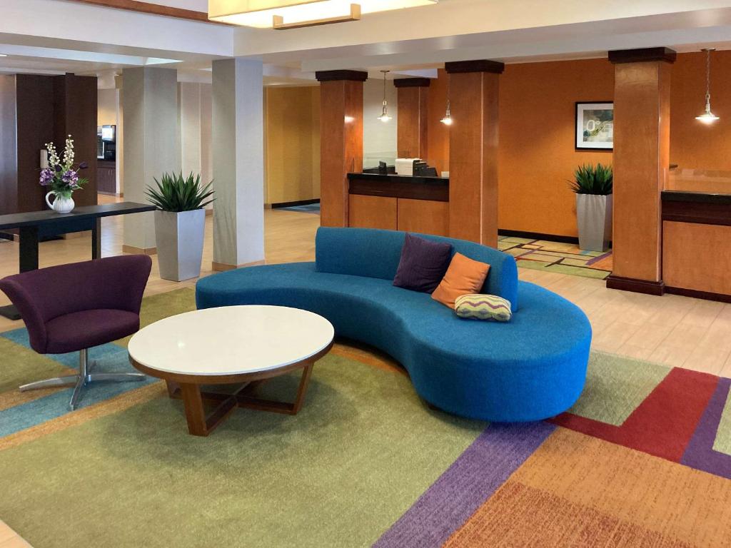 a living room with a blue couch and a table at Comfort Inn & Suites Ankeny - Des Moines in Ankeny