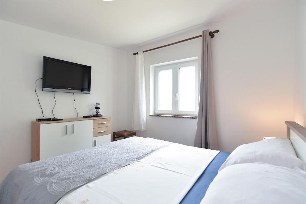 Łóżko lub łóżka w pokoju w obiekcie Apartments Fazana 407