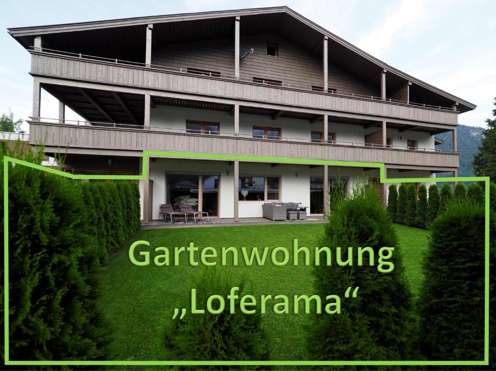 a large house with a garden and the words gardening volunteering liderarna at Loferama Top 1 in Lofer
