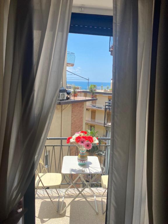 un vaso di fiori seduto su un tavolo sul balcone di Panoramic Rooms Salerno Affittacamere a Salerno