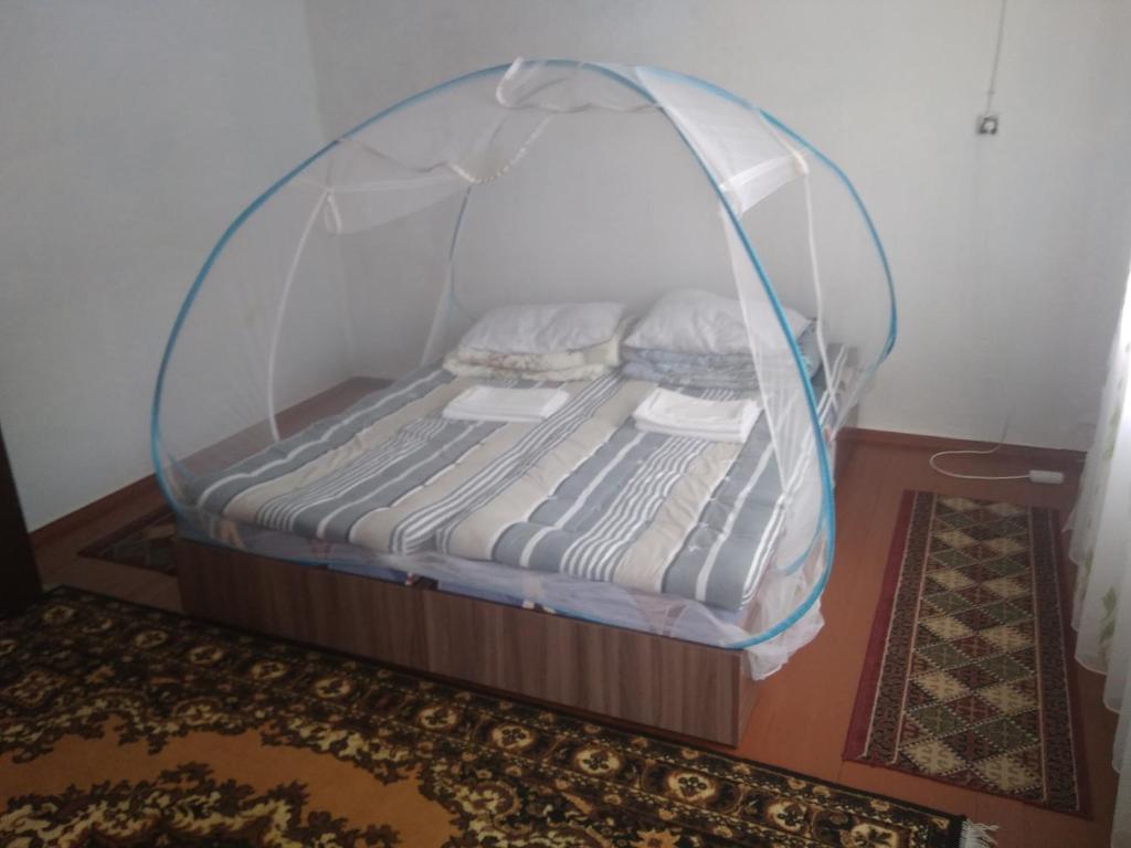 a bed with a canopy in a room at eco house summer garden in Kaji-Say