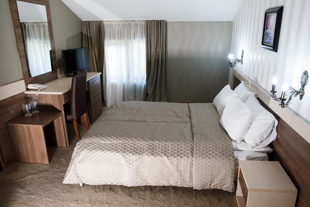 Postel nebo postele na pokoji v ubytování Spa Hotel Kleptuza