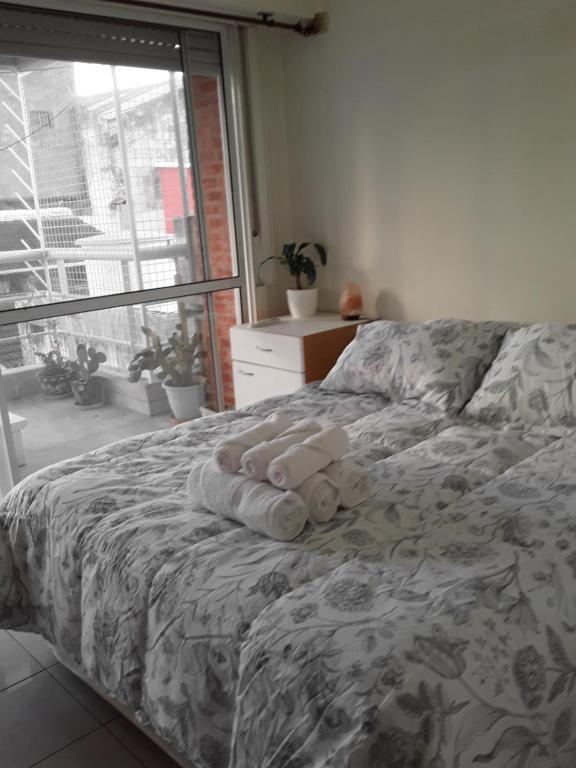 a bedroom with a bed with a teddy bear on it at Depto. Zuviria in Buenos Aires