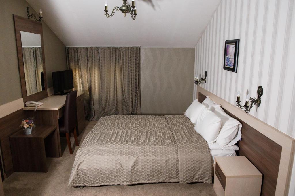 Postel nebo postele na pokoji v ubytování Spa Hotel Kleptuza