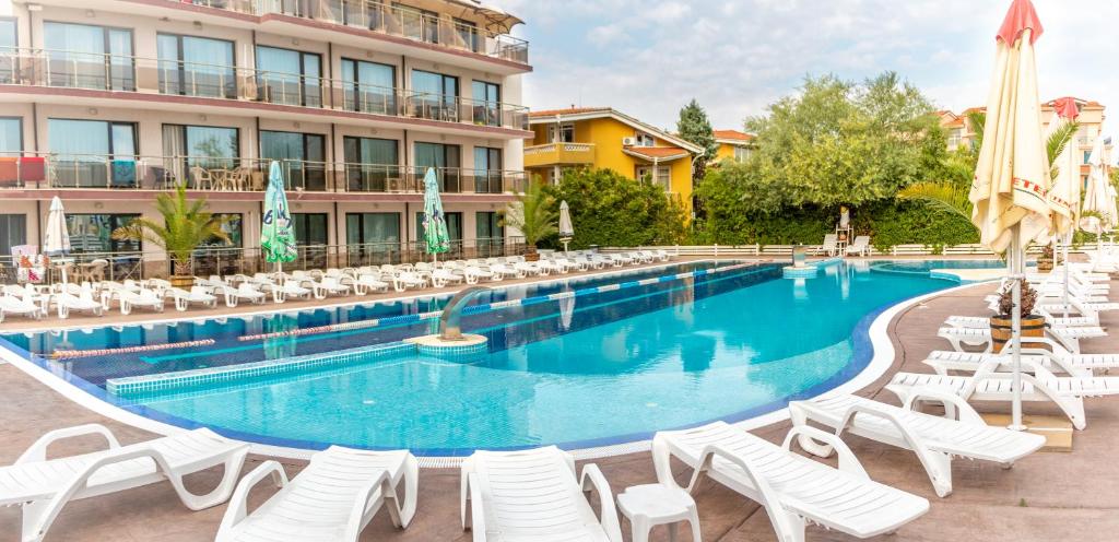 a swimming pool with lounge chairs and a hotel at Sozopoli Style Club in Sozopol