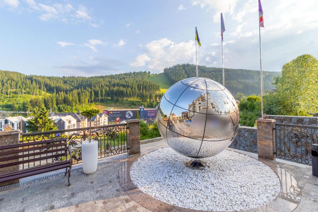 a large glass globe on a balcony with a view at MARION SPA - Breakfast included in the price Spa Swimming pool Sauna Hammam Jacuzzi Salt room Children's room Restaurant Parking 400 m to Bukovel Lift 1 Mountain view in Bukovel