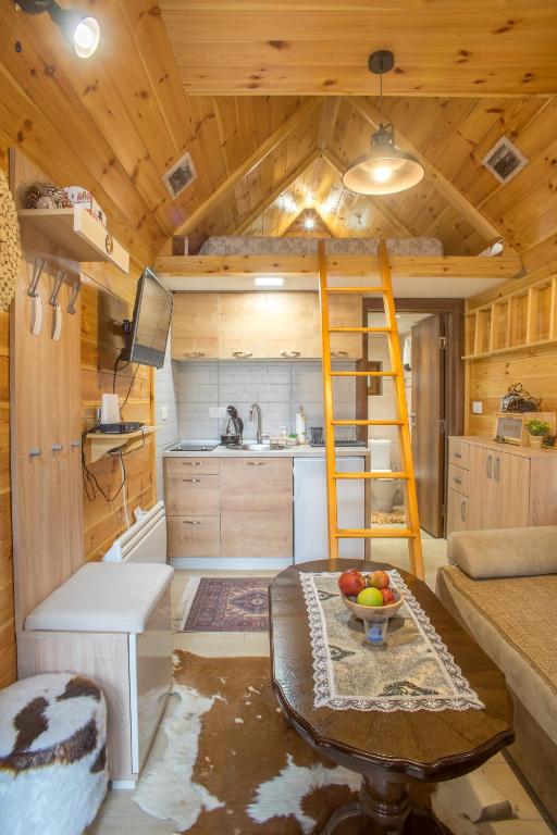 a tiny house with a ladder in a kitchen at Lux Bungalow in Žabljak