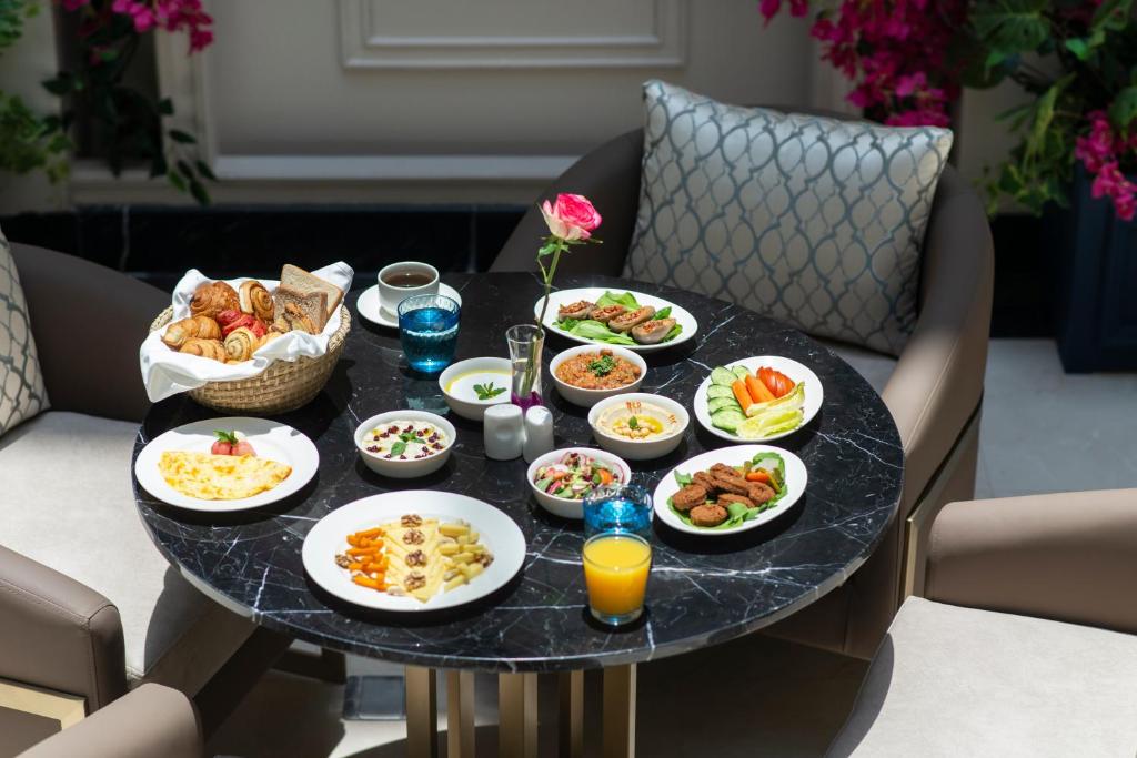 a table filled with plates of food on a table at Gardino Hotel & Residence in Riyadh