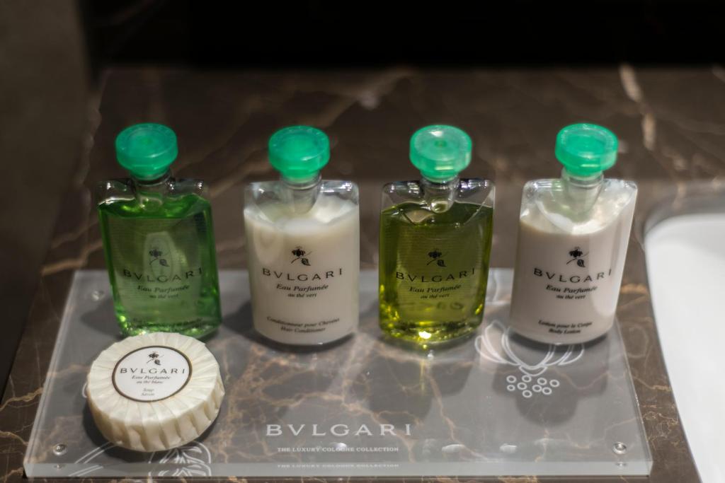 a tray with four bottles of perfume on it at Gardino Hotel & Residence in Riyadh