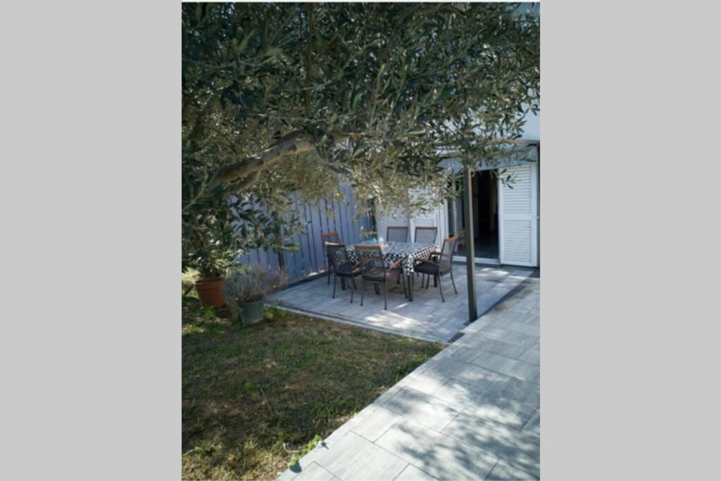 a patio with a table and chairs in a yard at Kati 1 in Sveti Filip i Jakov