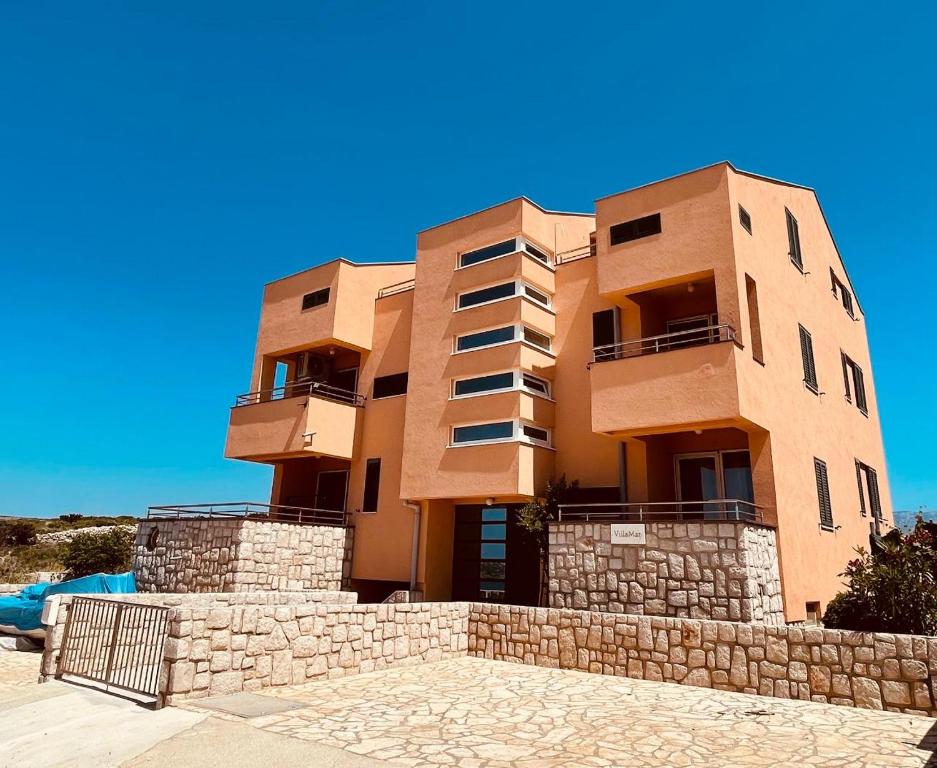 a building on top of a stone wall at VillaMar in Pag