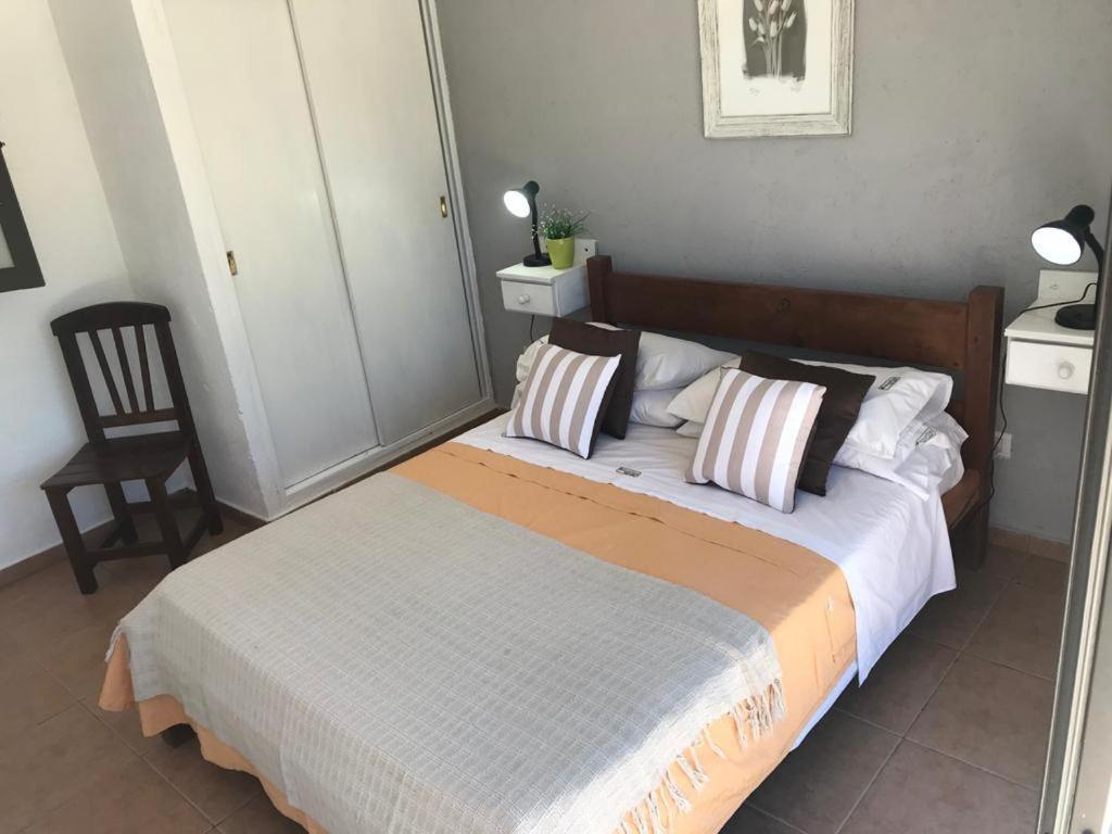 Ένα ή περισσότερα κρεβάτια σε δωμάτιο στο Aguaribay Apart